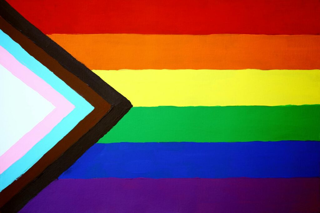 Close-up of the Progress Pride Flag symbolizing LGBTQ+ inclusivity and diversity.